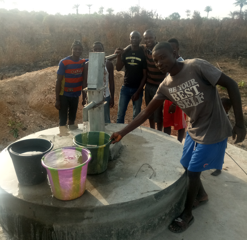 Men at clean water pump in Sierra Leone