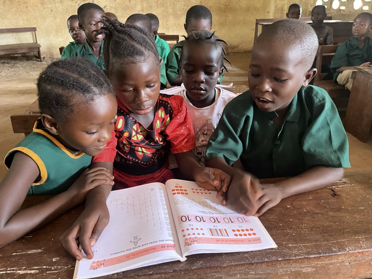 Students in Sierra Leone sitting at new school desks.