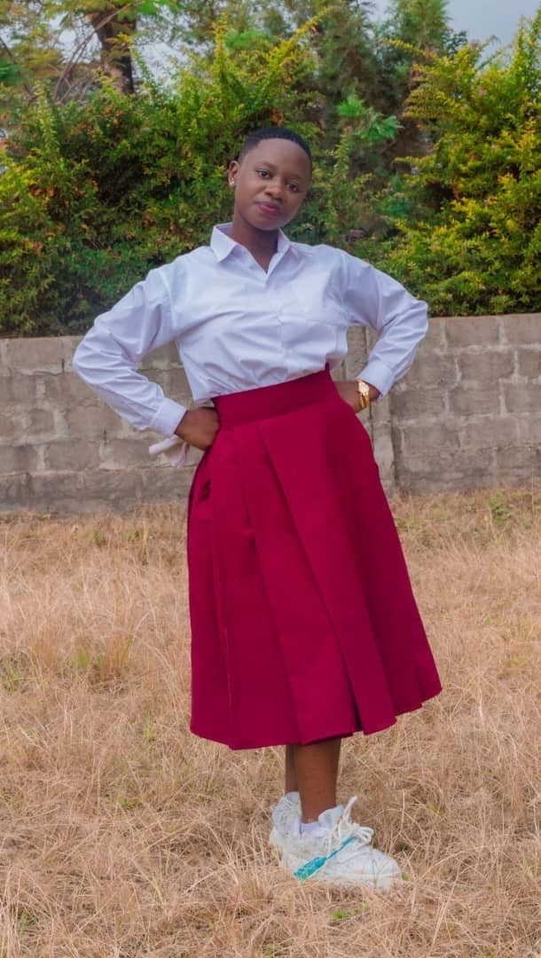 Margaret, a young woman supported by Watoto Wa Africa, standing confidently and preparing for higher education.