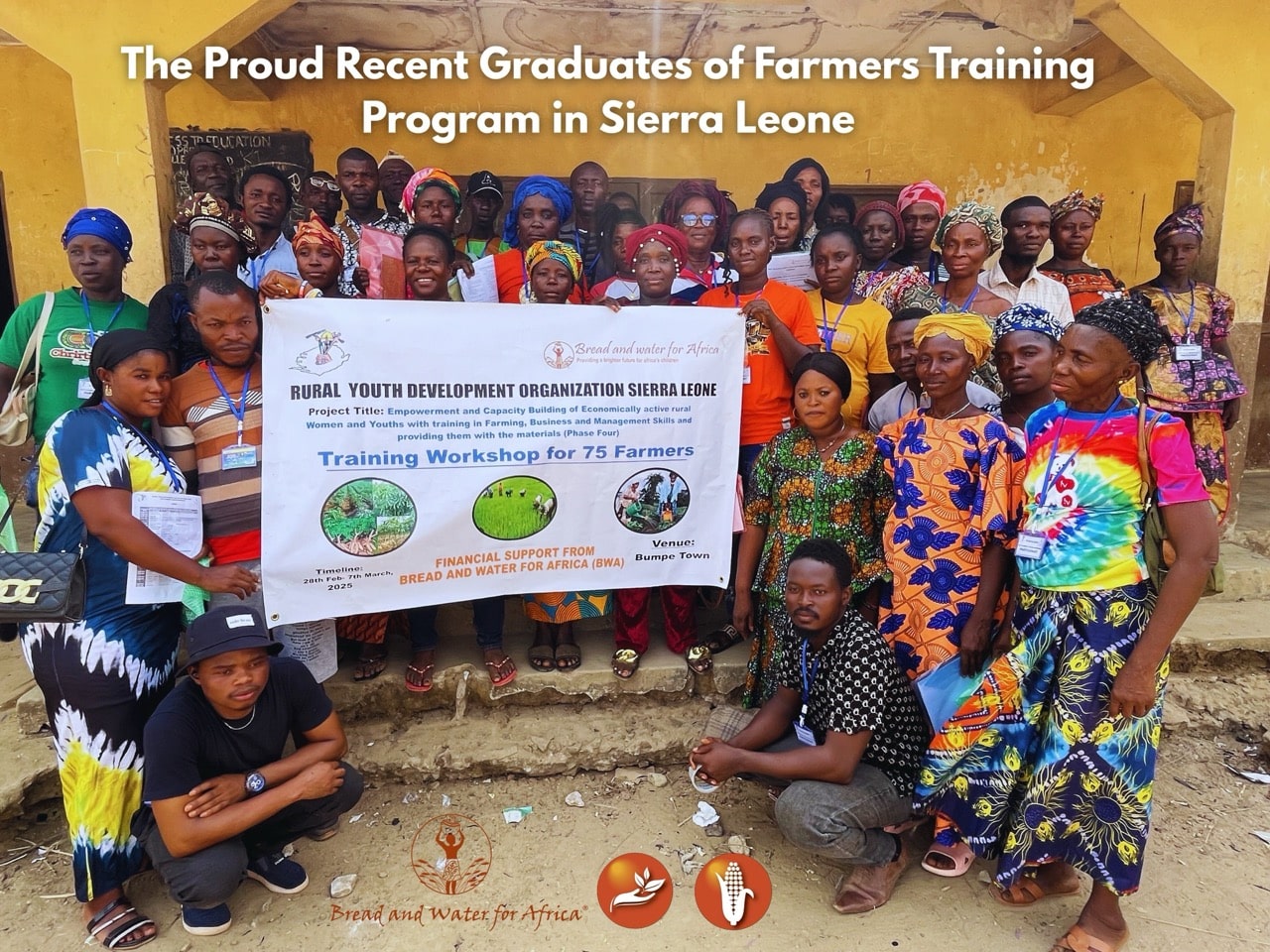 Group of recent graduates holding a banner at a farmers training program in Sierra Leone.