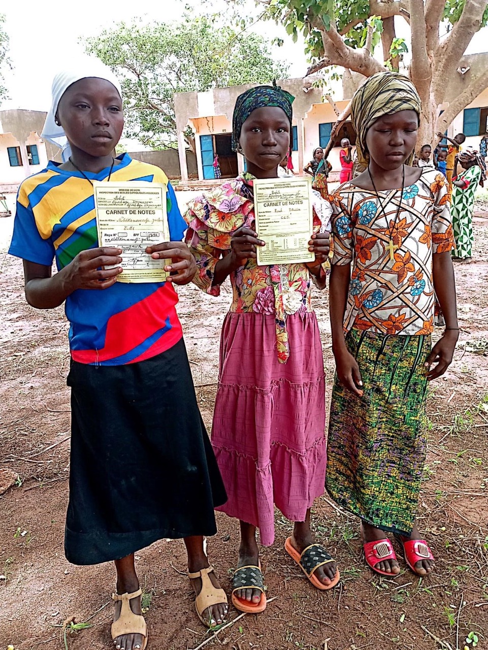 Hope International Foundation Chad education support program children holding school records in village